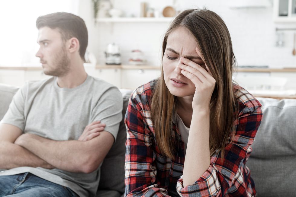 couple conflict stressed crying female sitting on couch with abusive husband after quarrel, ready to divorce