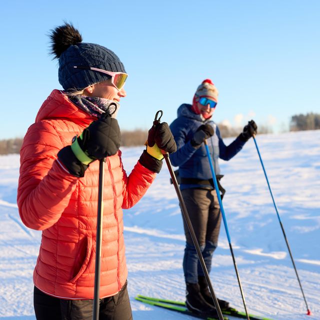 couple cross country skiing on ski track