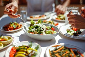 couple  eating lunch with fresh salad and appetizers