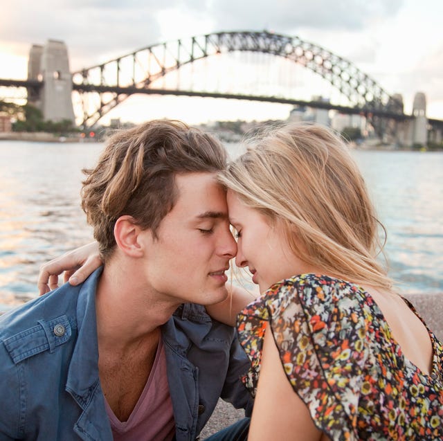 couple embracing in front of sydney harbour bridge