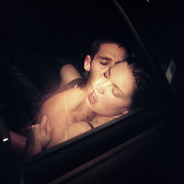 couple embracing passionately in car