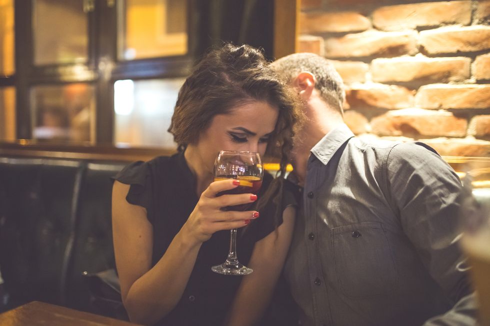 couple enjoying night out at cocktail bar