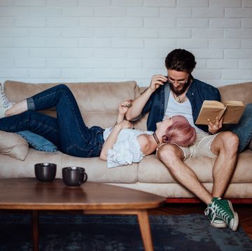 couple hanging out with each other reading book