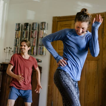 couple having fun working out at home together