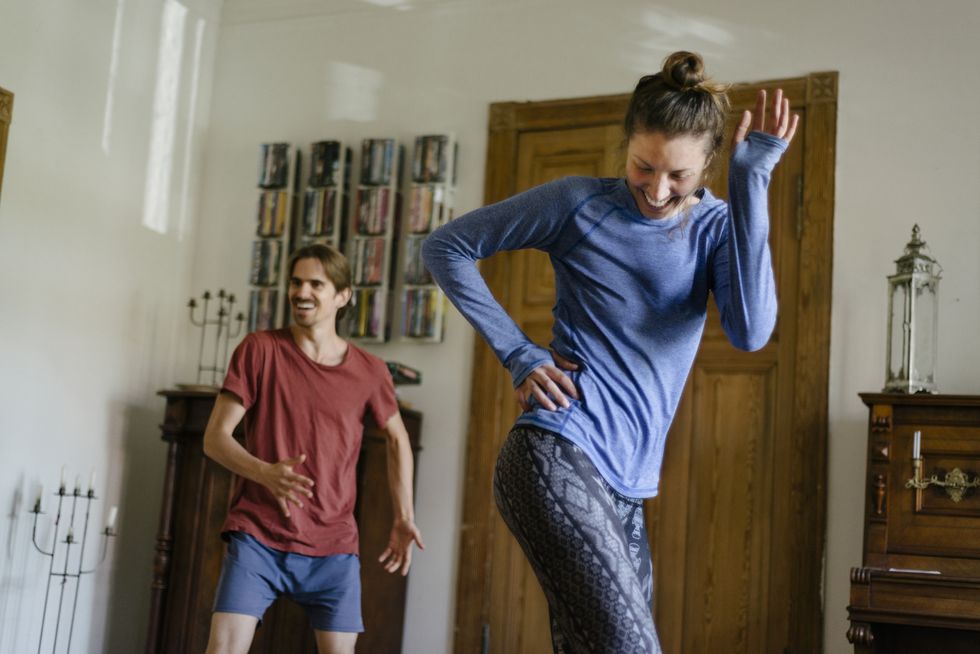 couple having fun working out at home together