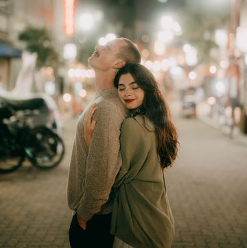 couple having romantic moment in tokyo street at night