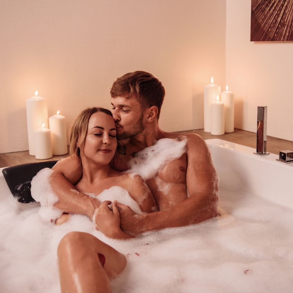 couple in bubble bath with champagne
