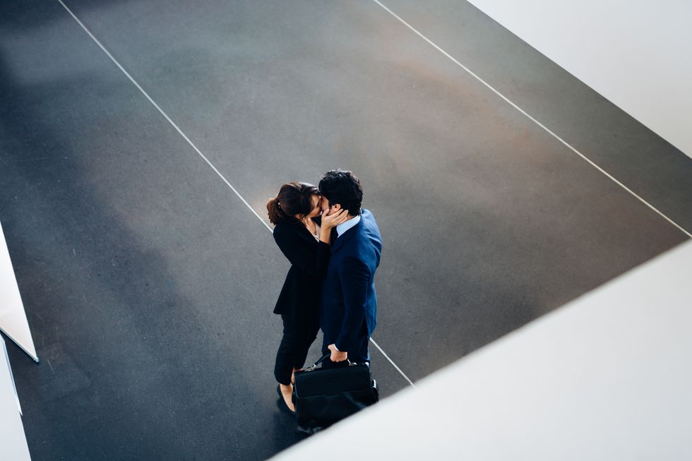 Couple in business suits kissing