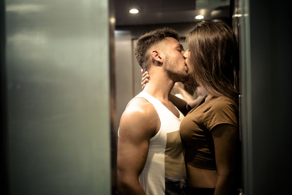 couple in love kissing in elevator