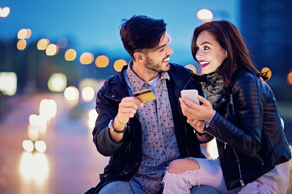 Couple is shopping online on the bridge in the night