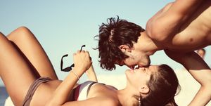 Couple kissing at beach, Italy