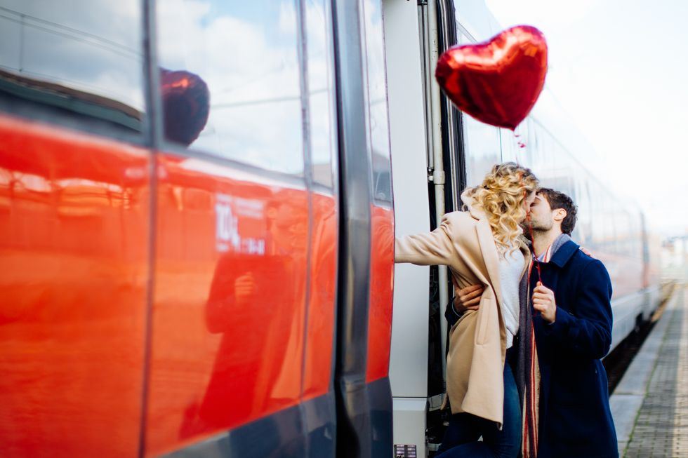 couple kissing beside train, firenze, toscana, italy
