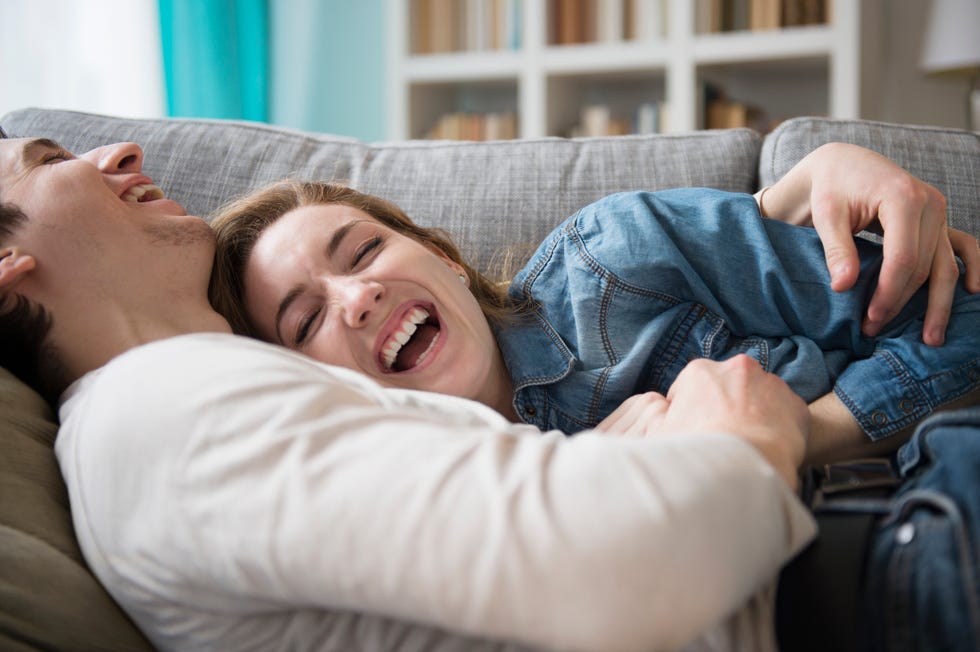 couple laughing together on couch