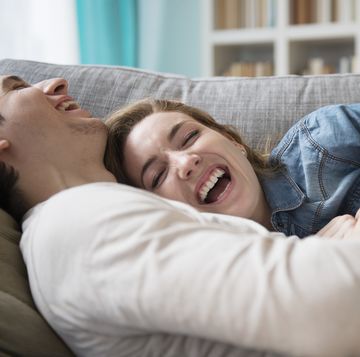 couple laughing together on couch