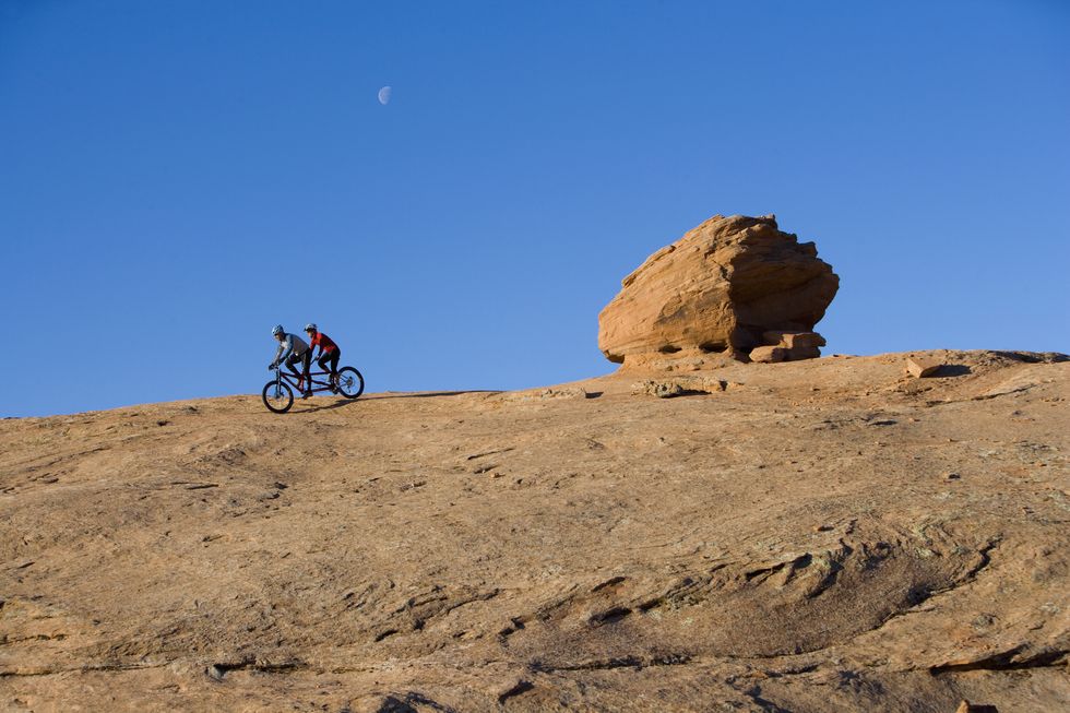 couple mountain biking on tandem