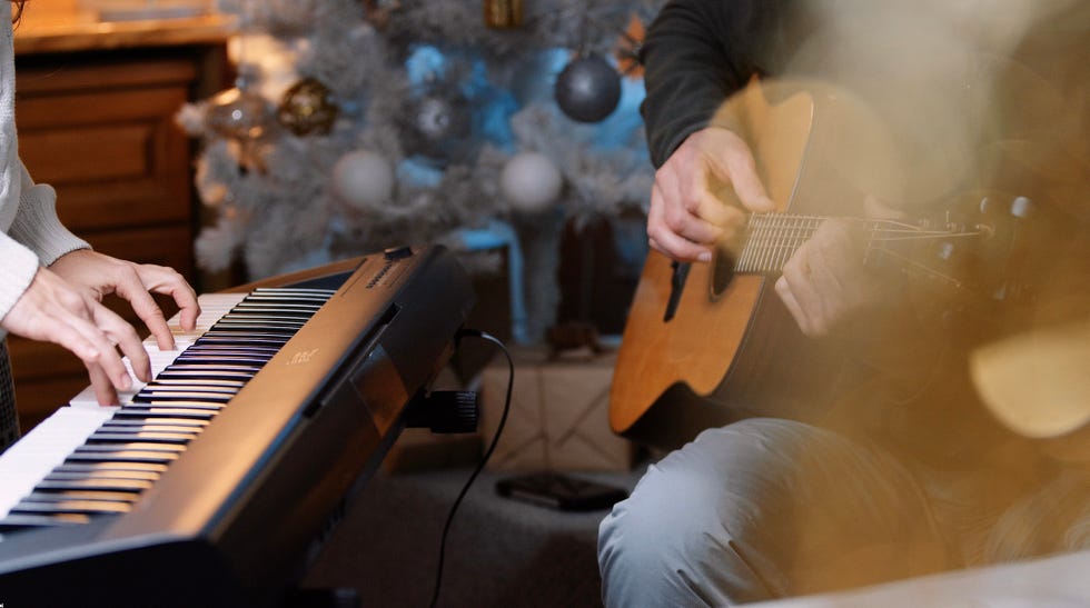 couple playing music together on christmas eve at home