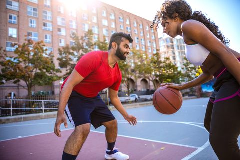 couple playing outdoor at city basketball court