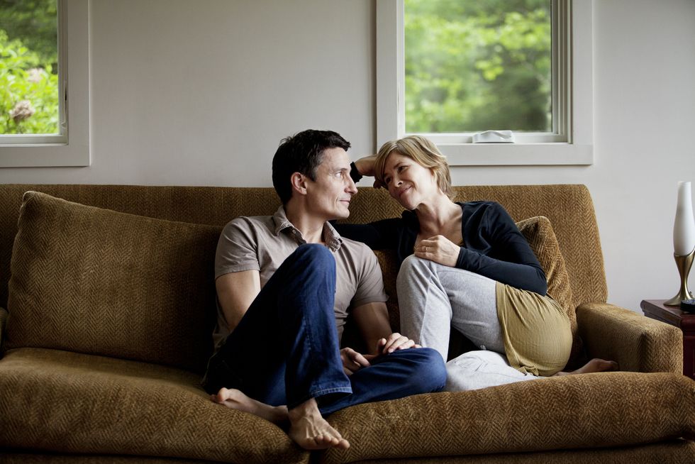 couple sitting on sofa at home