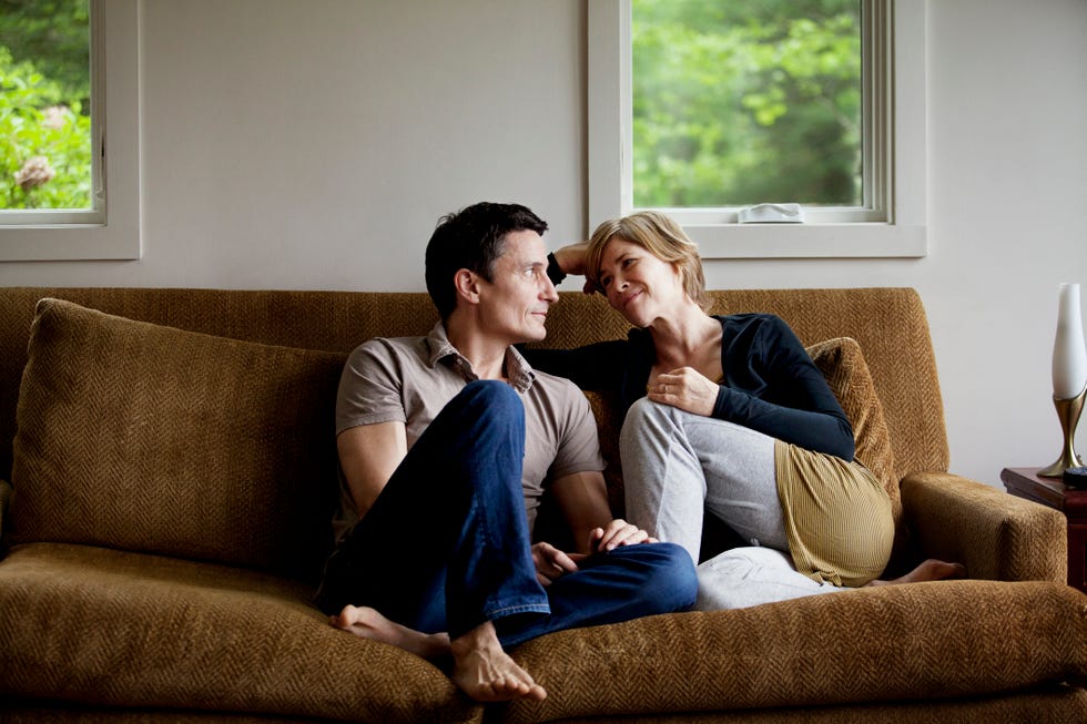 couple sitting on sofa at home