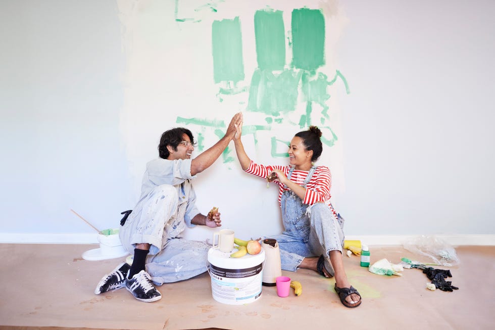 couple taking break while renovating home