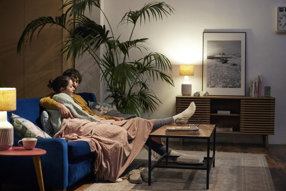 couple talking while watching tv in living room