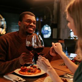 couple having romantic dinner with wine and pasta
