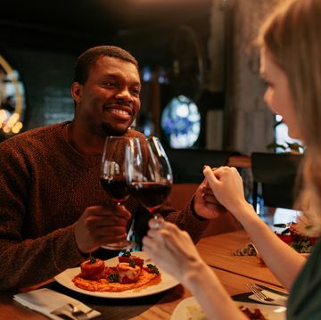 couple having romantic dinner with wine and pasta