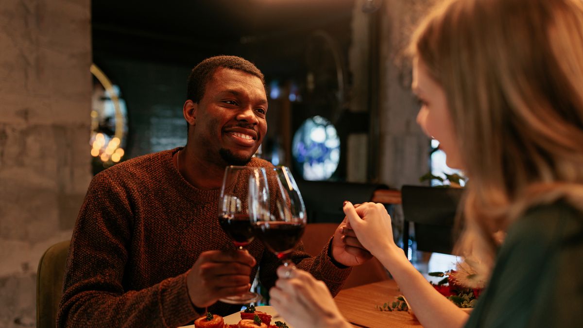 couple having romantic dinner with wine and pasta