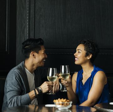 couple toasting wine glasses at restuarant