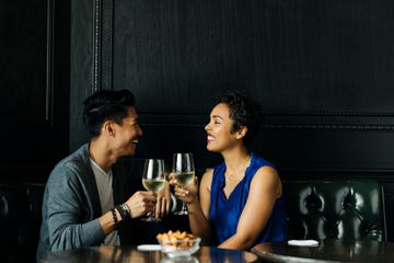 couple toasting wine glasses at restuarant