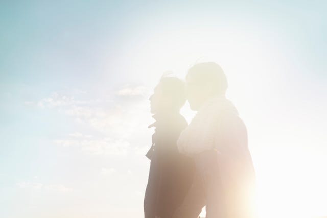 couple walking on the pavement at sunset