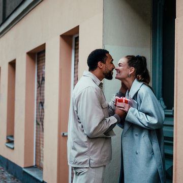 couple with a holiday present on a doorstep