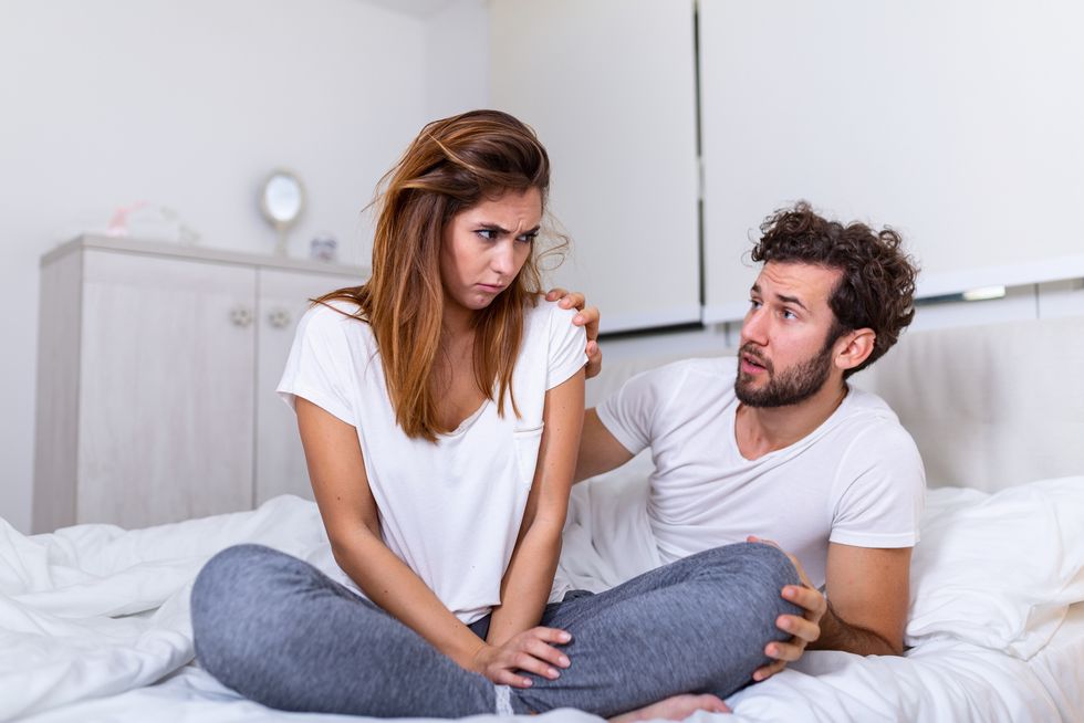 couple with problems having disagreement in bed frustrated couple arguing and having marriage problems, young couple into an argument on bed in bedroom