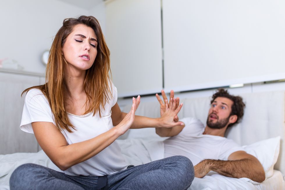 couple with problems having disagreement in bed frustrated couple arguing and having marriage problems, young couple into an argument on bed in bedroom