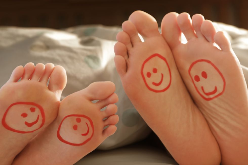 couples happy feet in bed