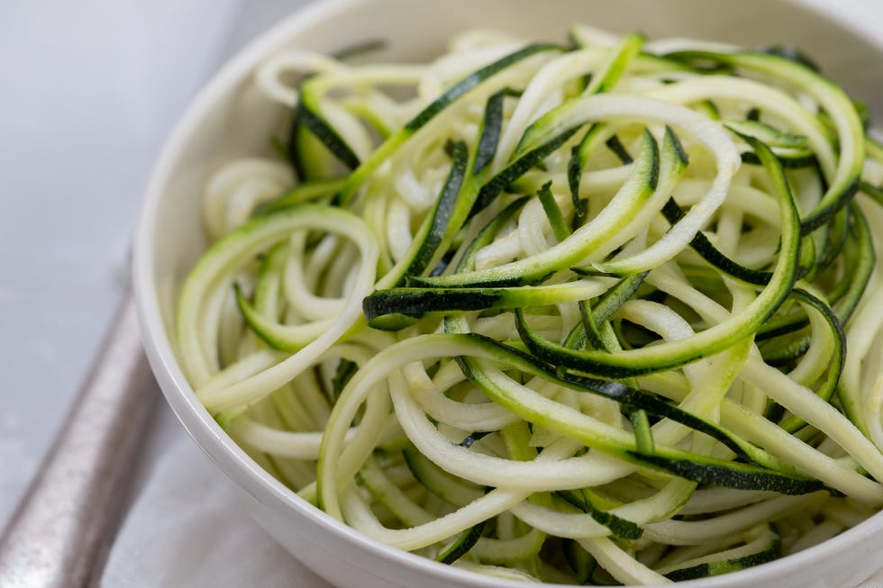 courgette noodles in bowl on gray ceramic background