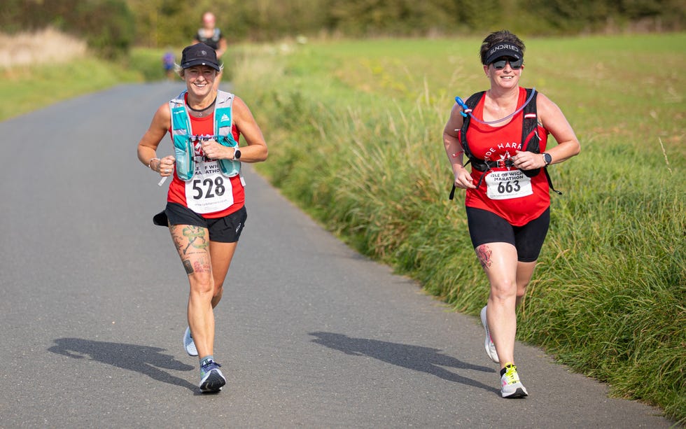 two people running on a road