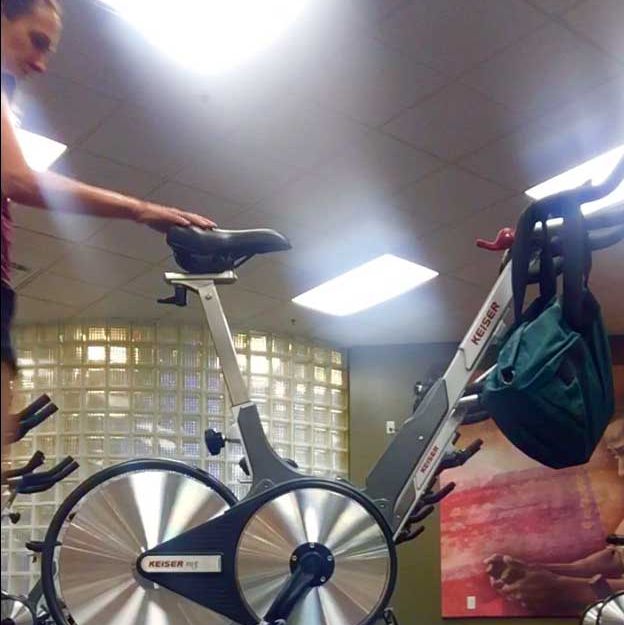 kathryn bertine's spin bike with her dad in the bag