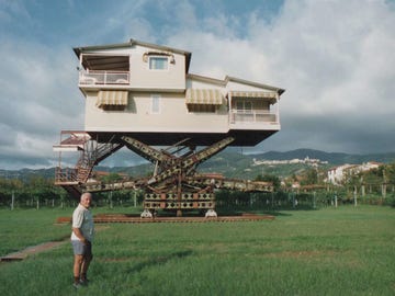 a person standing in front of a building that is being built