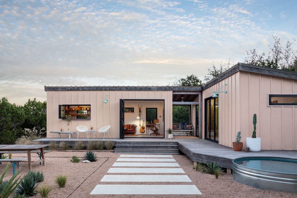 modern house with outdoor patio and landscaping