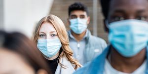 authentic shot of multiracial people in the city wearing face mask to represent the pandemic