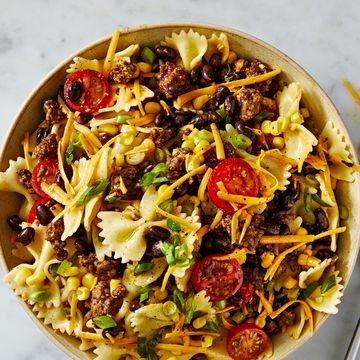 cowboy pasta salad with bowtie pasta, tomatoes, ground beef, cheese, corn, and black beans