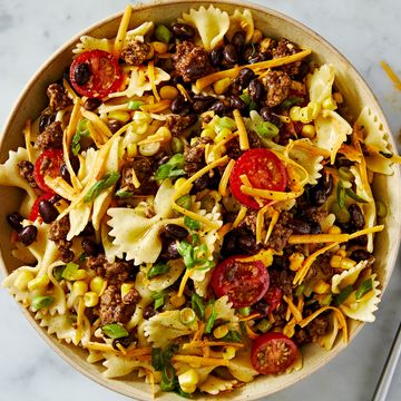 cowboy pasta salad with bowtie pasta, tomatoes, ground beef, cheese, corn, and black beans