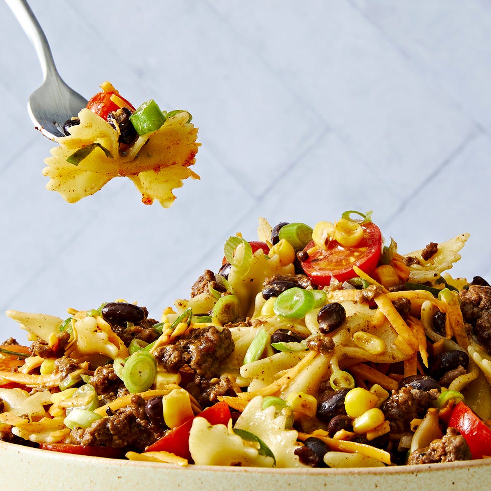 cowboy pasta salad with bowtie pasta, tomatoes, ground beef, cheese, corn, and black beans