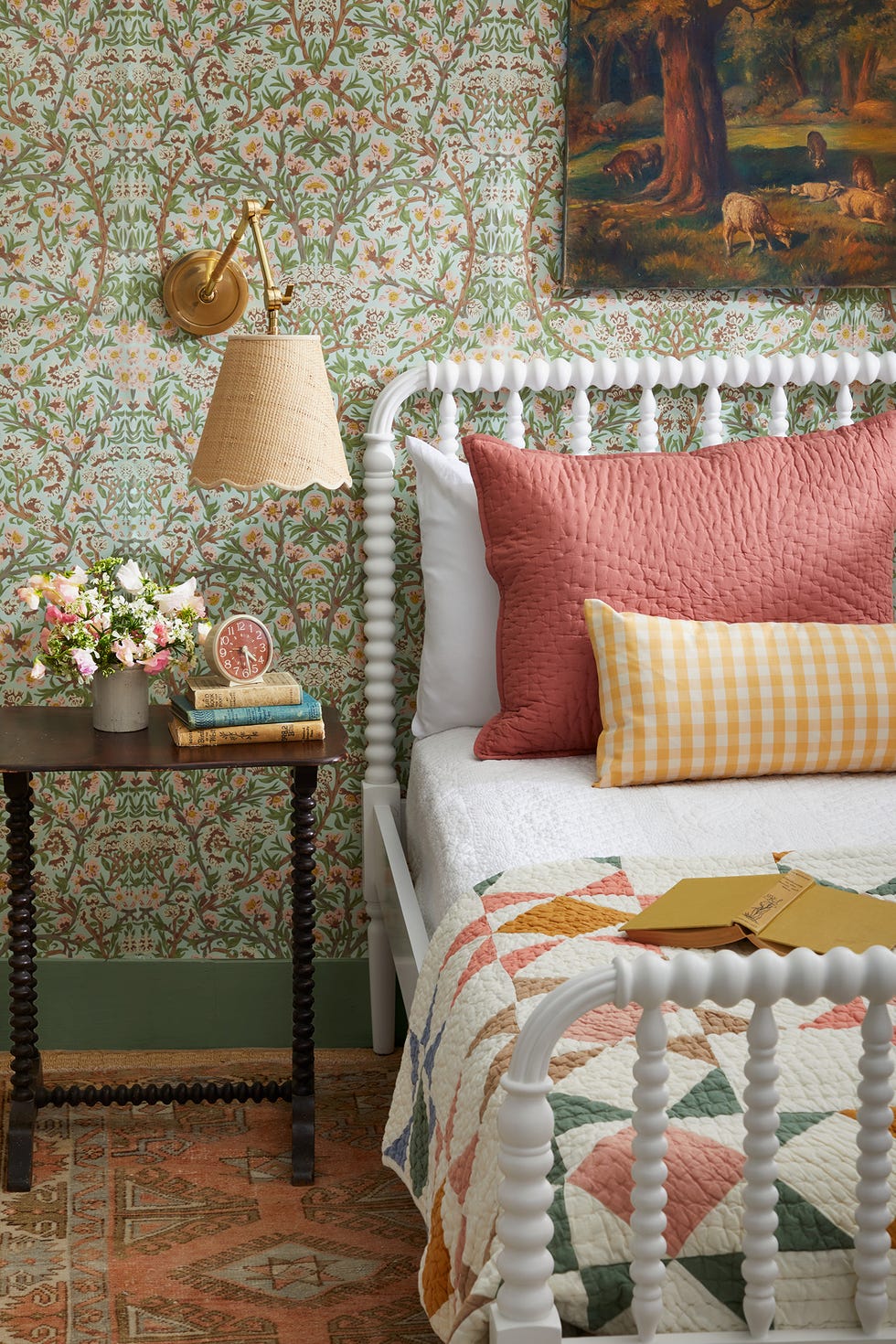 guest room bedroom with a white jenny lind bed and wallpaper and a quilt