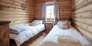 separate beds in a cozy cabin bedroom