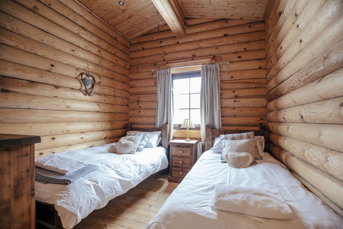 cozy bedroom with twin beds in cabin