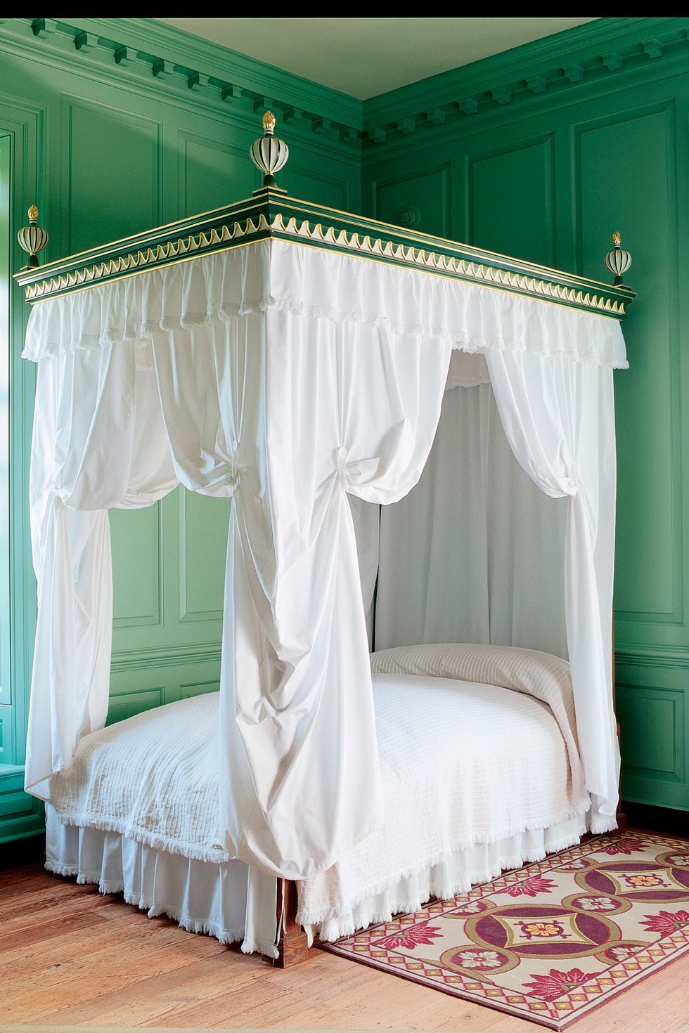 green bedroom with canopy
