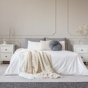 cozy cream colored woolen blanket on king size bed in bright bedroom