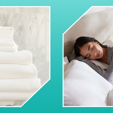 stack of bath towels, woman in bed with white pillows and comforters